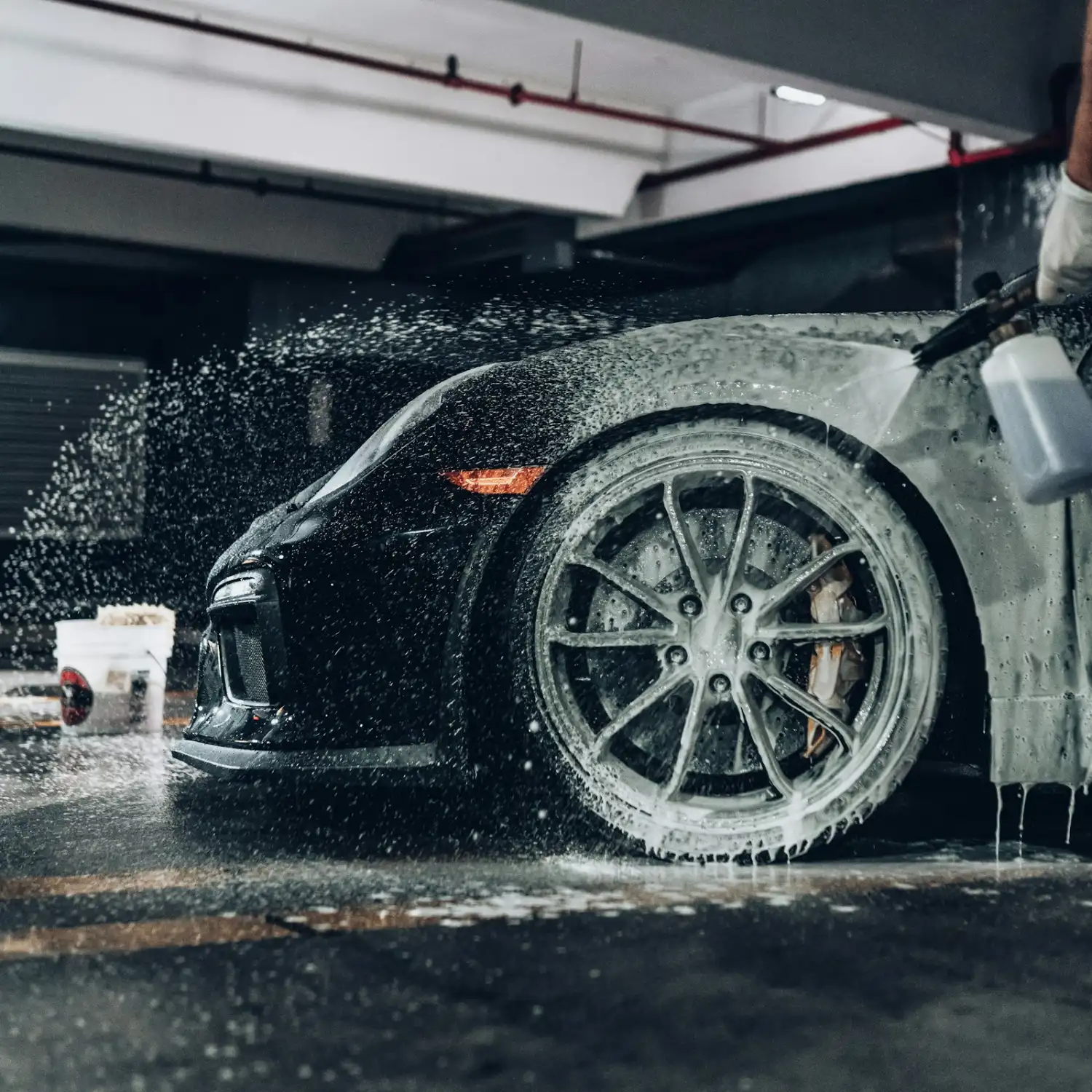 Snow foam on a black sports car