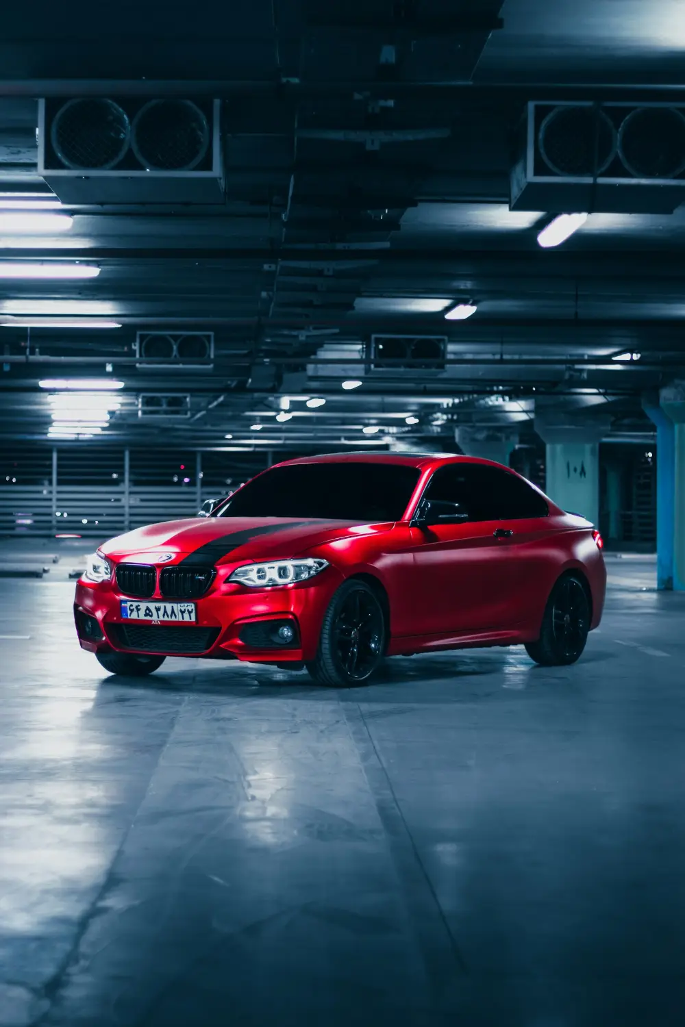 Red coupe in an underground car park