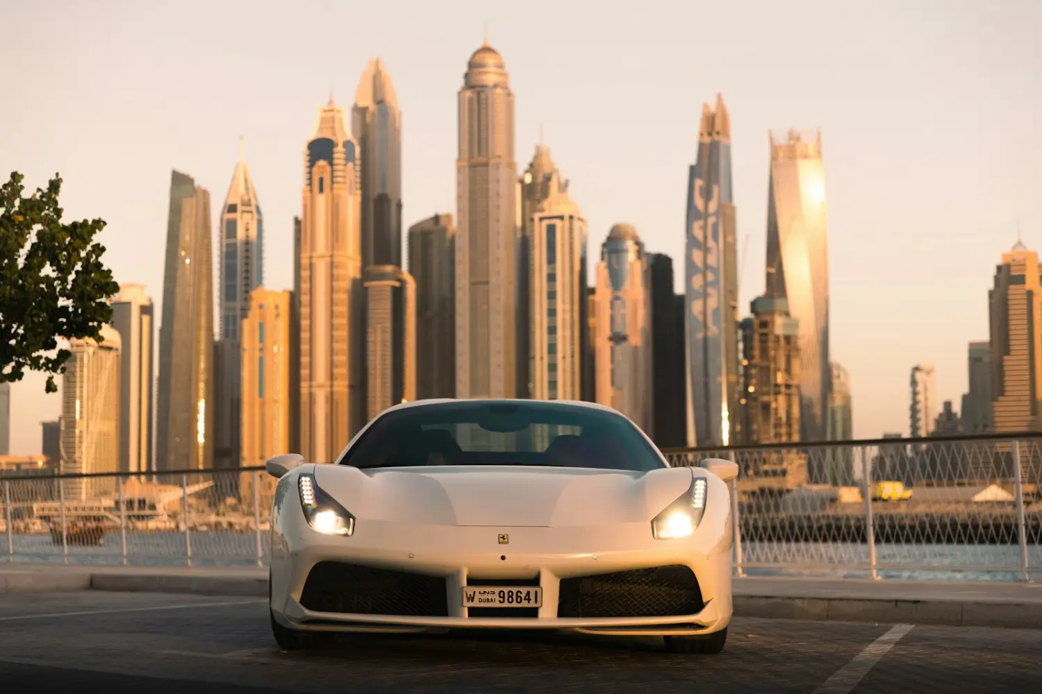 White sports car in front of the Dubai skyline