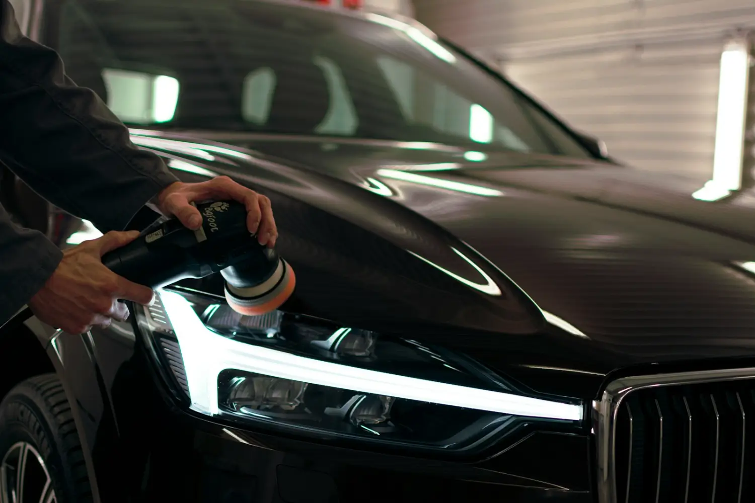 Detailer polishing a headlight